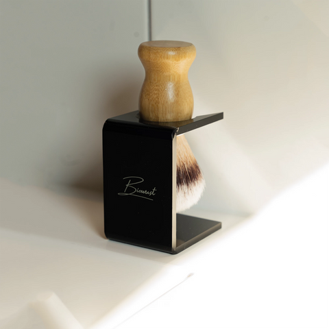 Achterzijde van de acryl houder met scheerkwast op een wastafel.